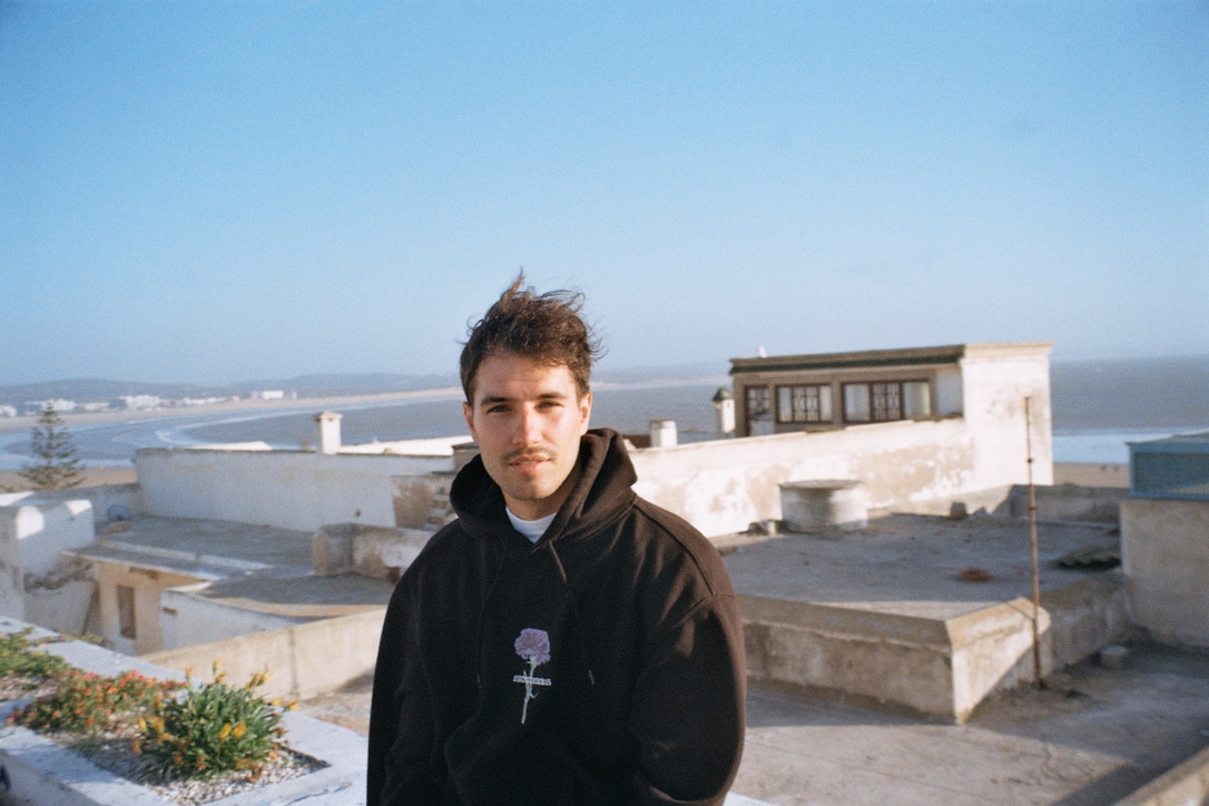 Lukas Wolf on a rooftop overlooking the ocean